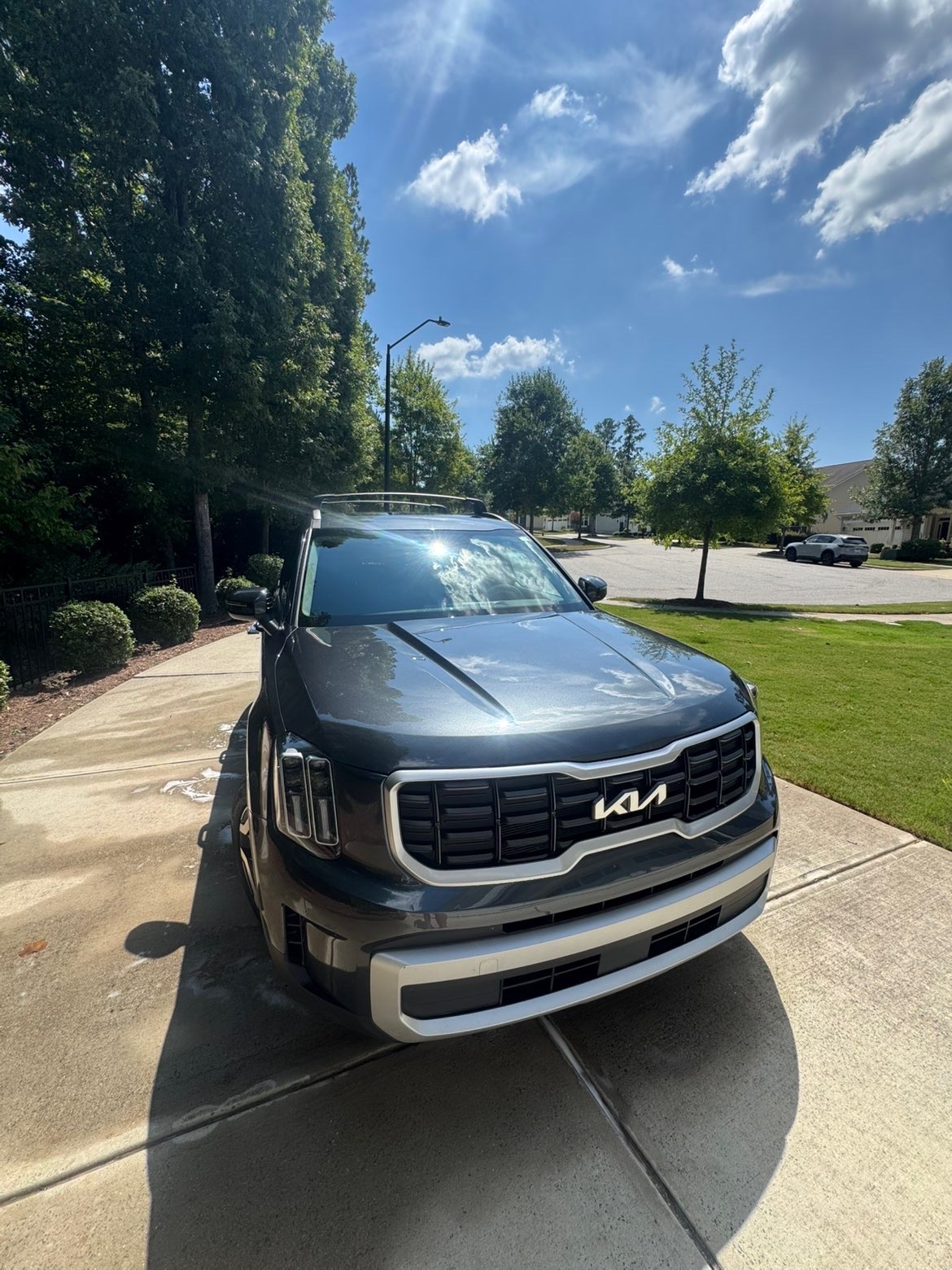 Freshly detailed dark blue Kia SUV with a glossy finish after a full detail